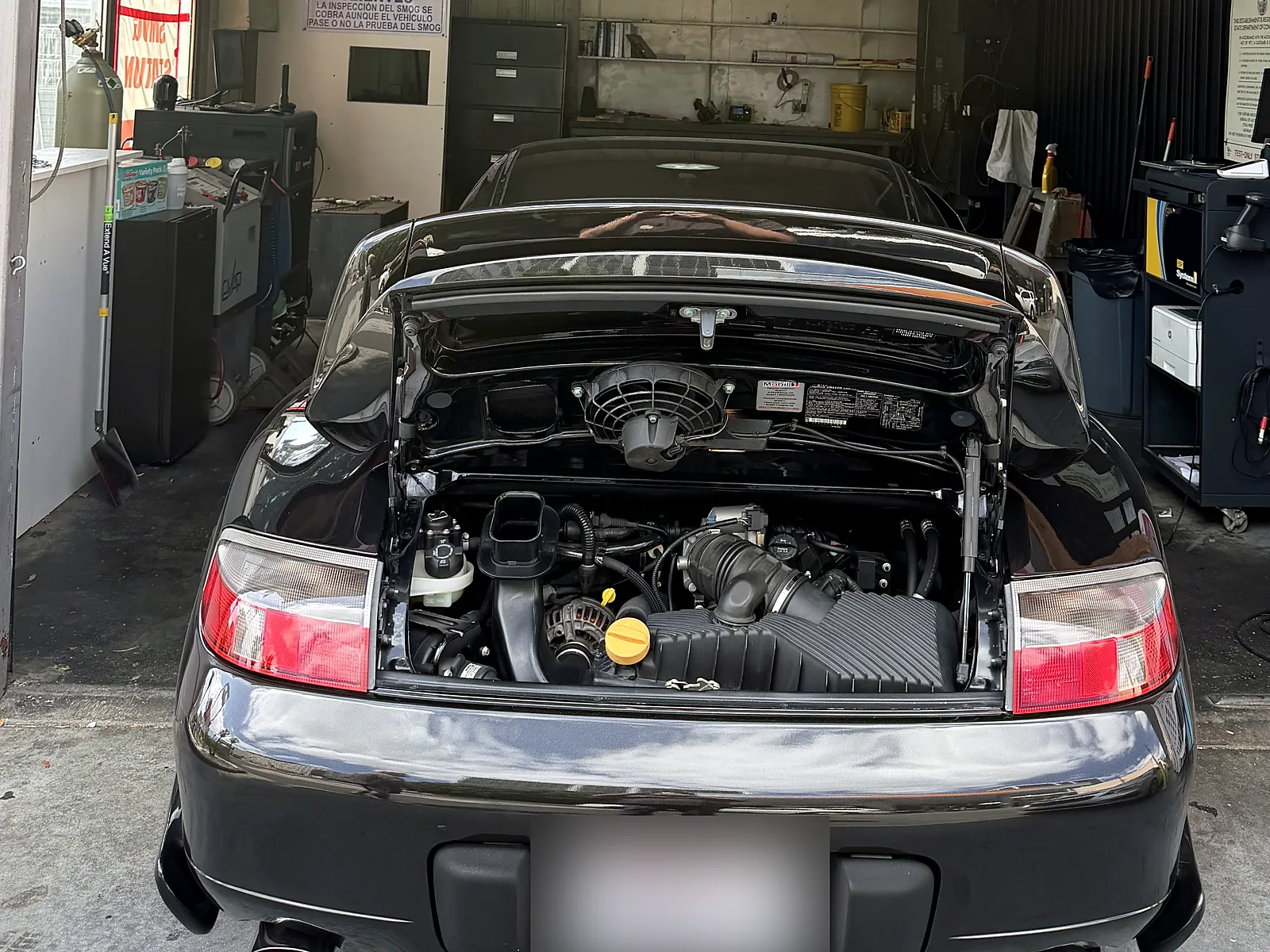 Failed smog check help in Los Angeles, CA: Porsche 911 with the engine lid open in our test lane